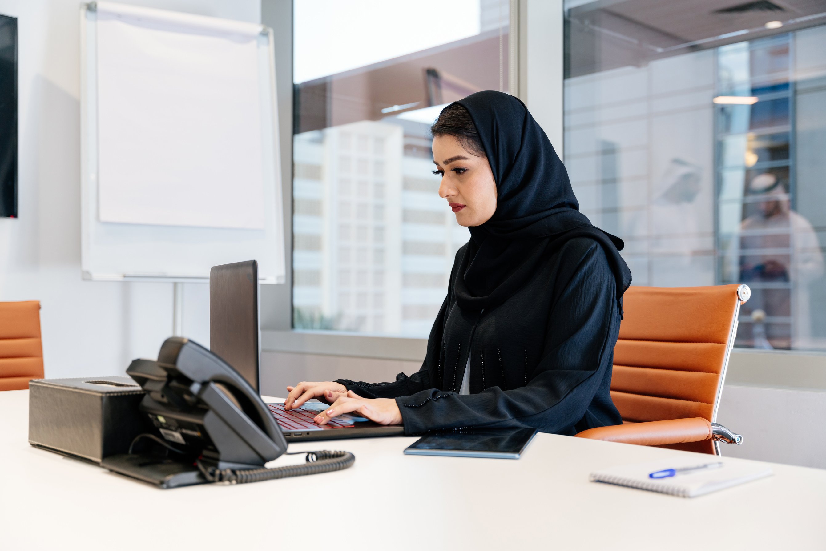 Employee Typing on a Laptop 